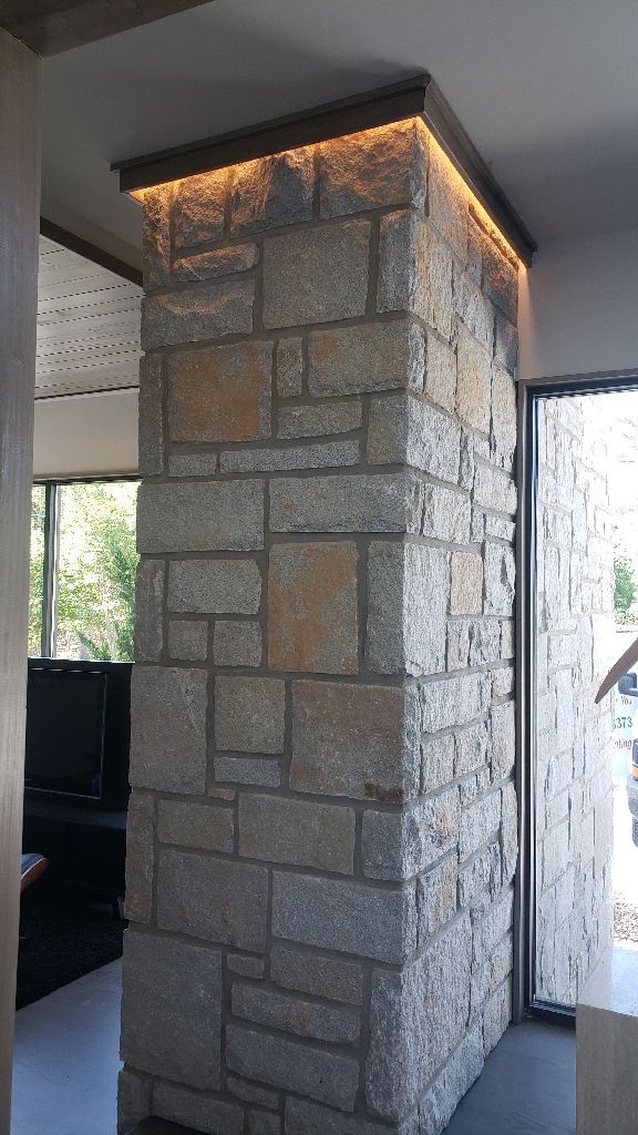 Stone column with warm lighting. Interior shot.
