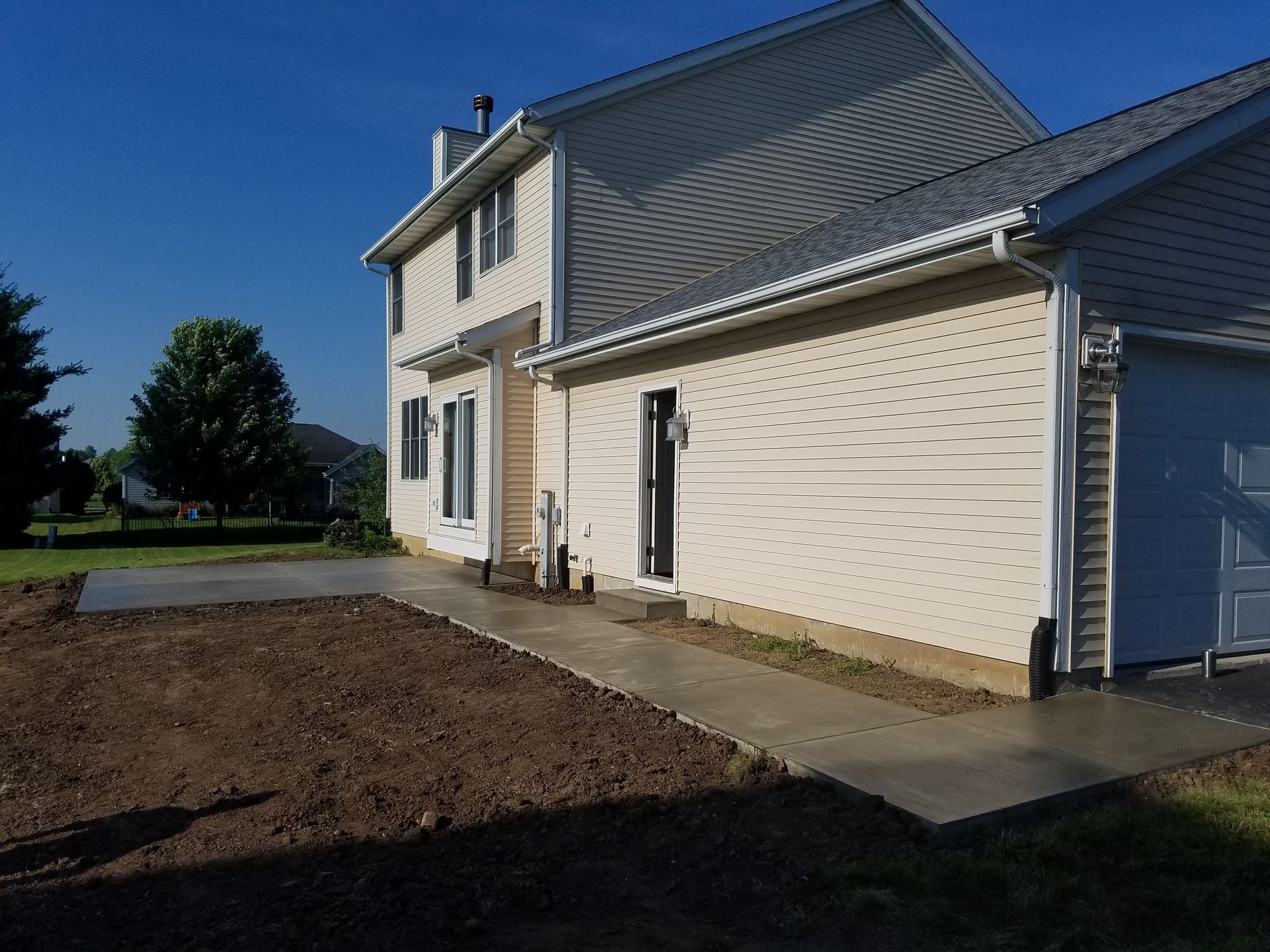 A house with a concrete walkway leading to it