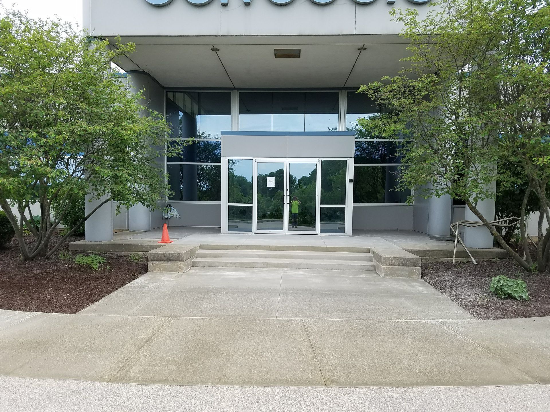A large building with a concrete walkway leading to it