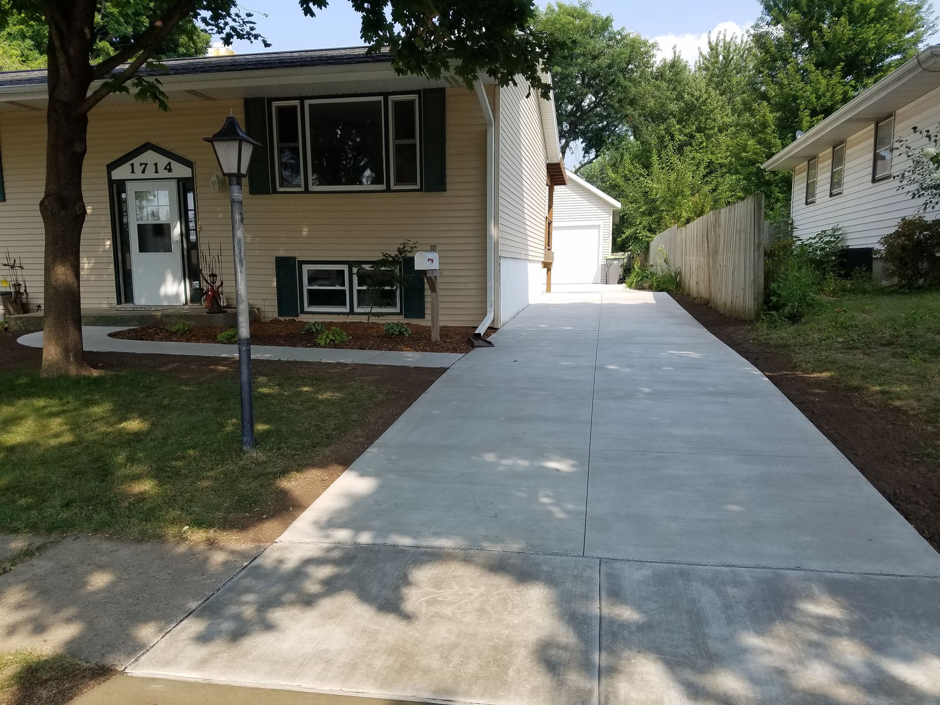 A house with a concrete driveway leading to it