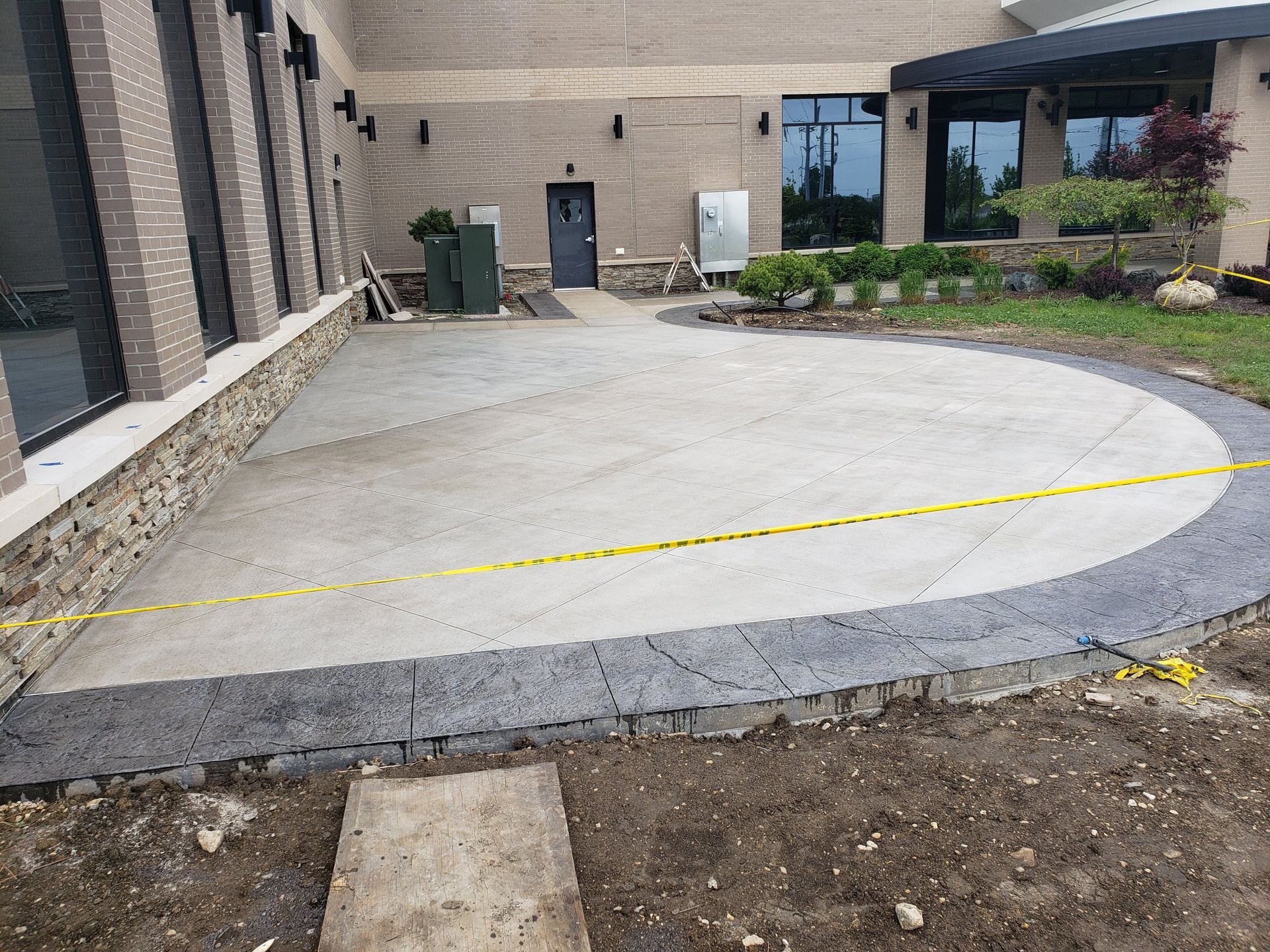 A concrete patio is being built in front of a building.