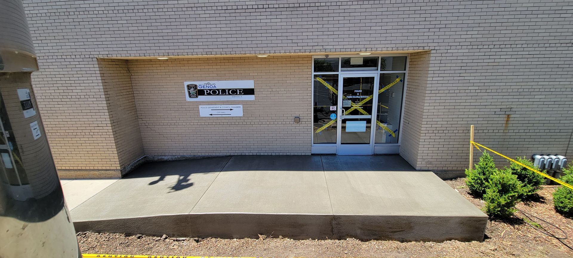 A concrete walkway is being built in front of a building.