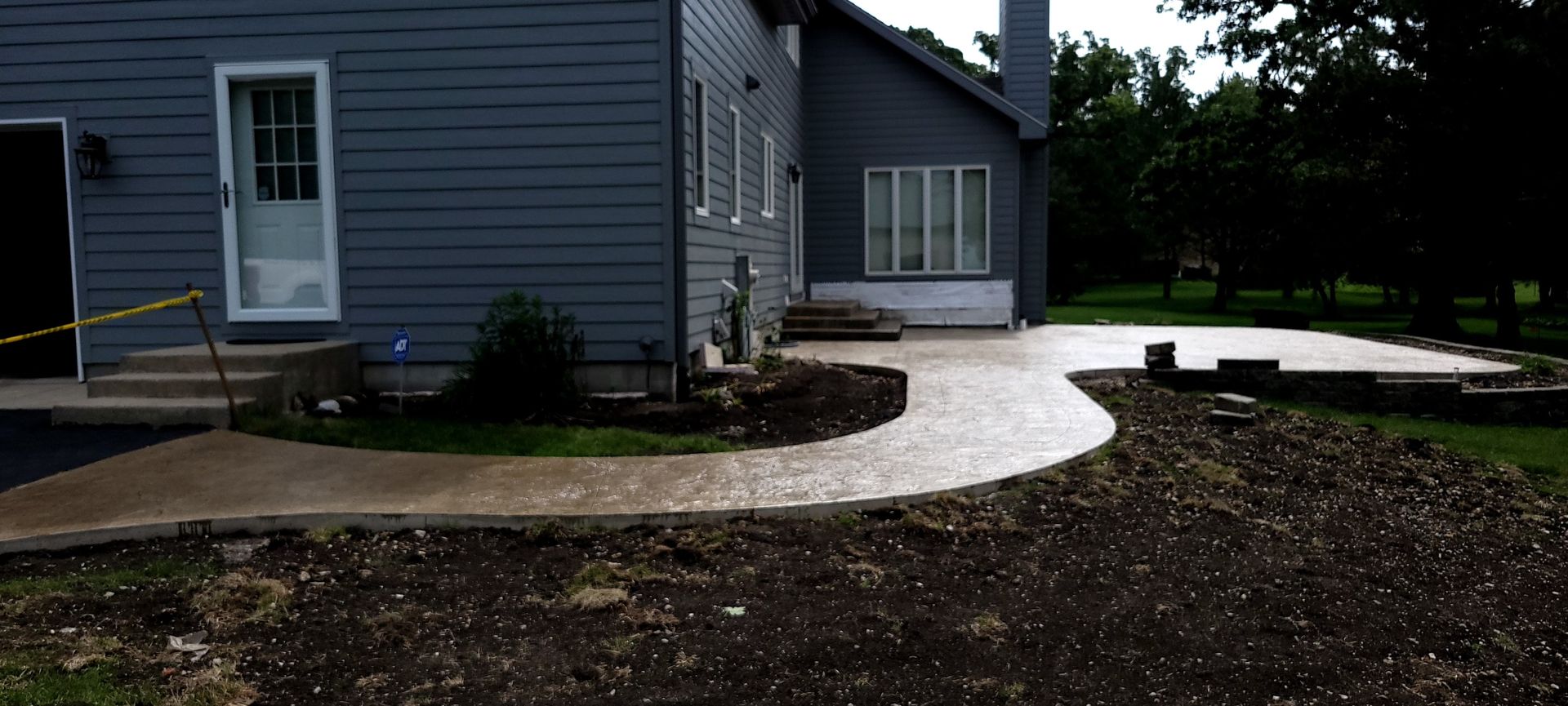 A house with a concrete walkway in front of it