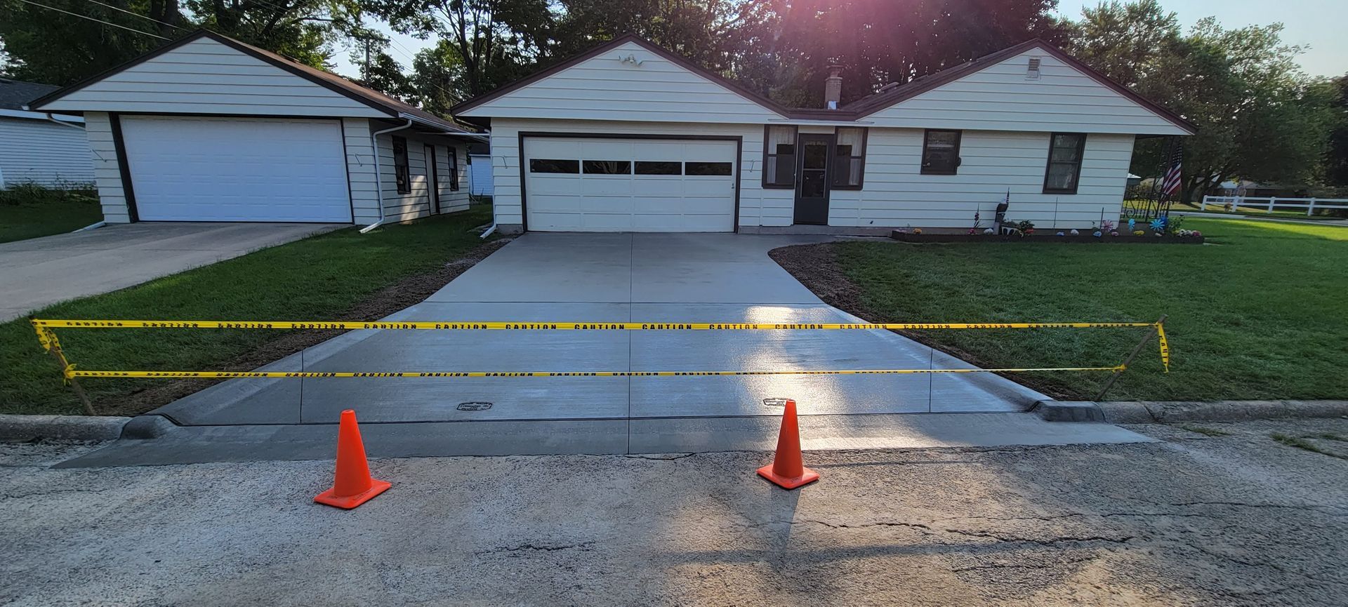 A concrete driveway is being built in front of a house.