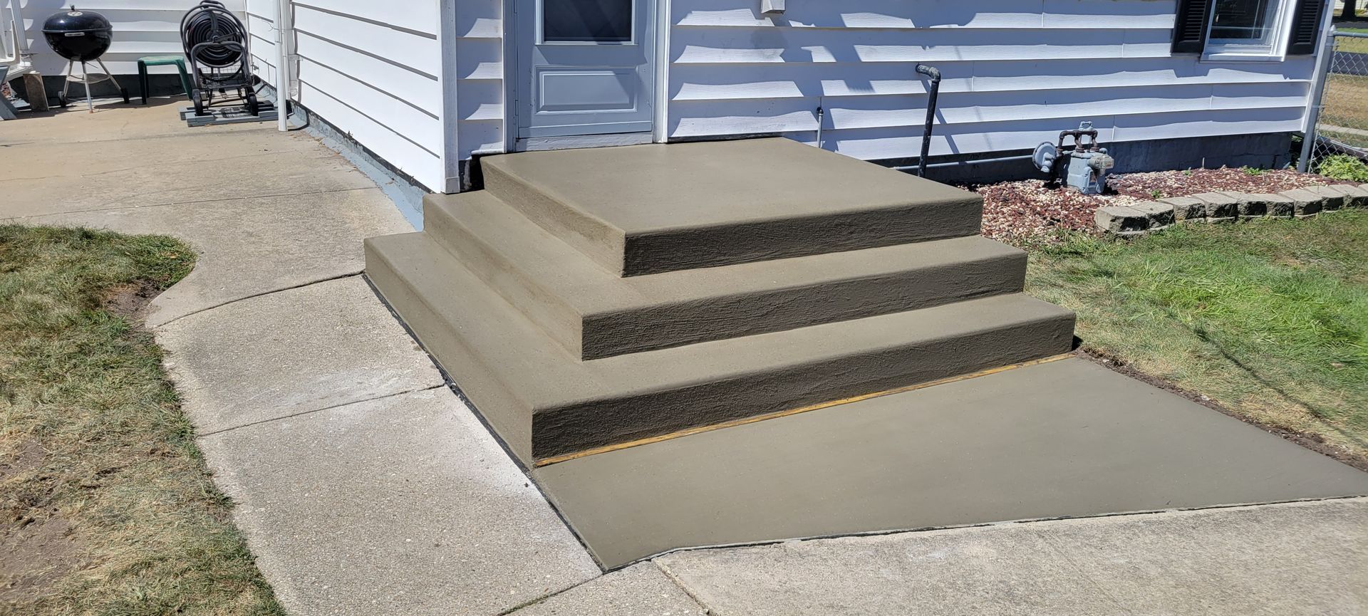 A set of concrete steps leading up to a house.
