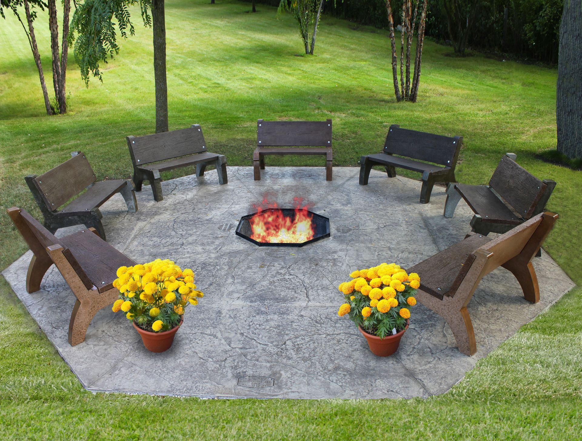 A fire pit is surrounded by benches and flowers