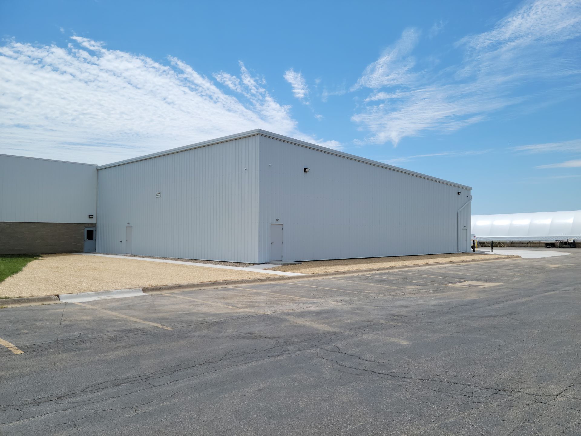 A large white building with a blue sky in the background.
