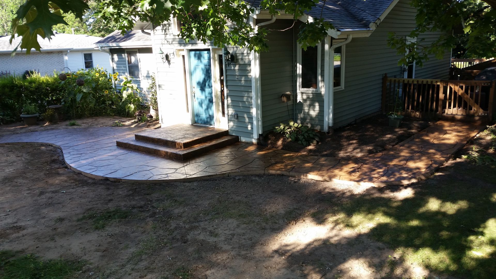 A small house with a concrete patio in front of it