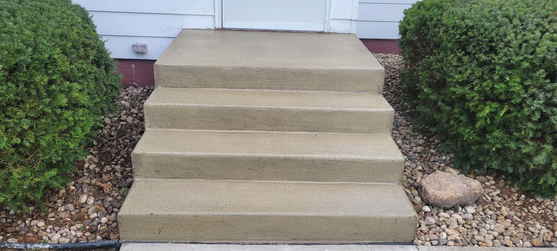 A set of concrete steps leading up to a house.