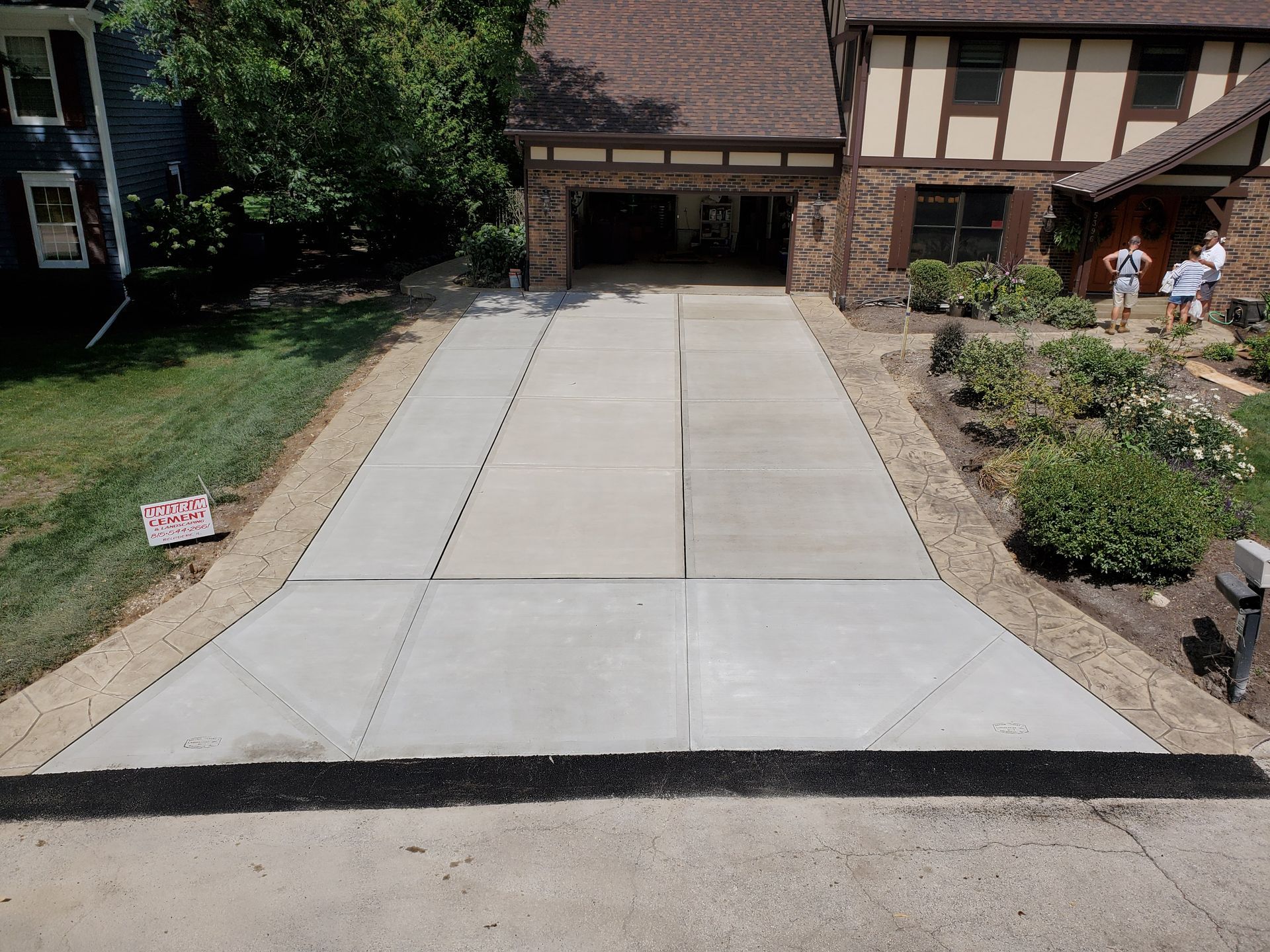 A concrete driveway in front of a house