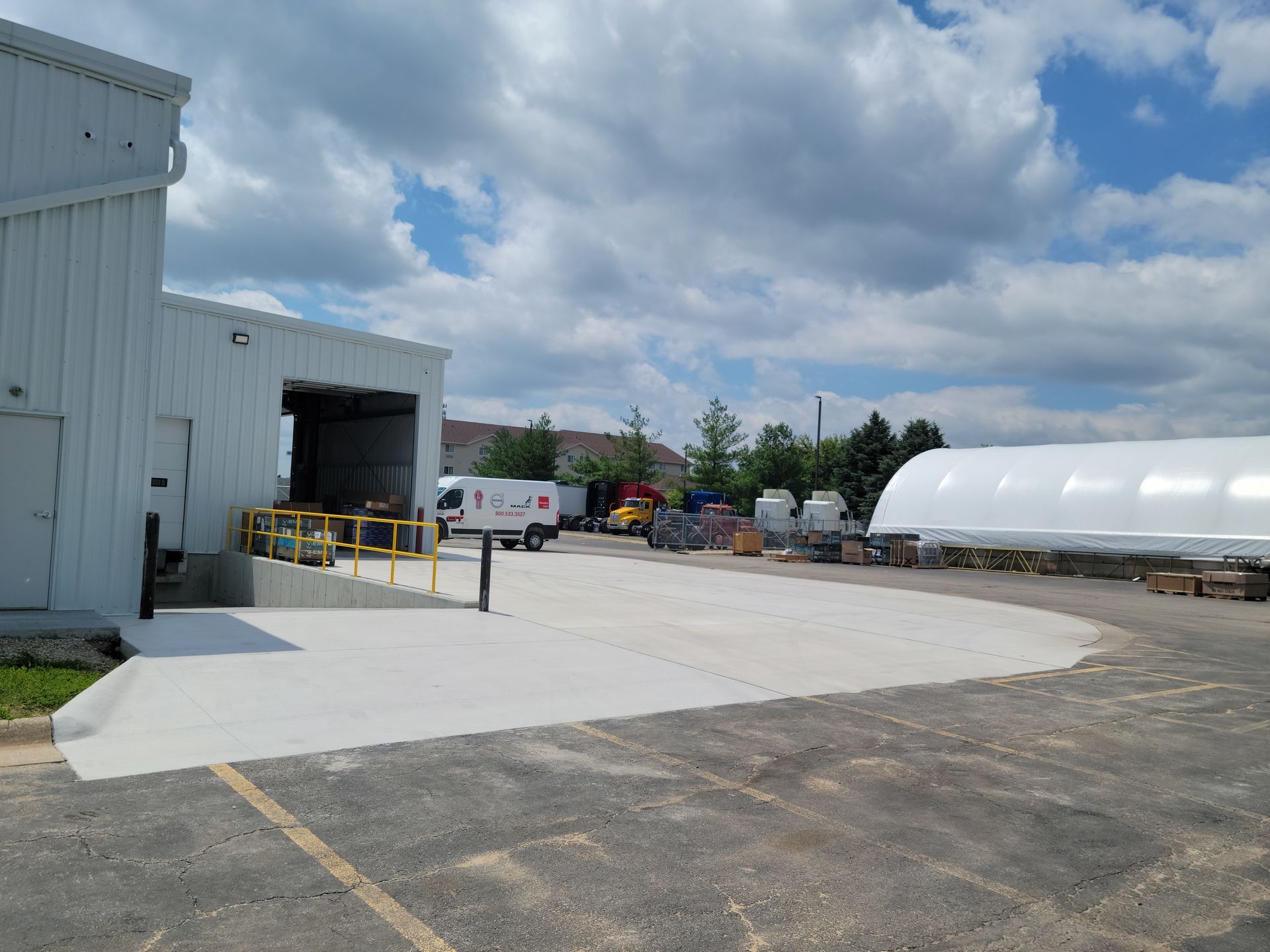 A large white building with a lot of trucks parked in front of it.