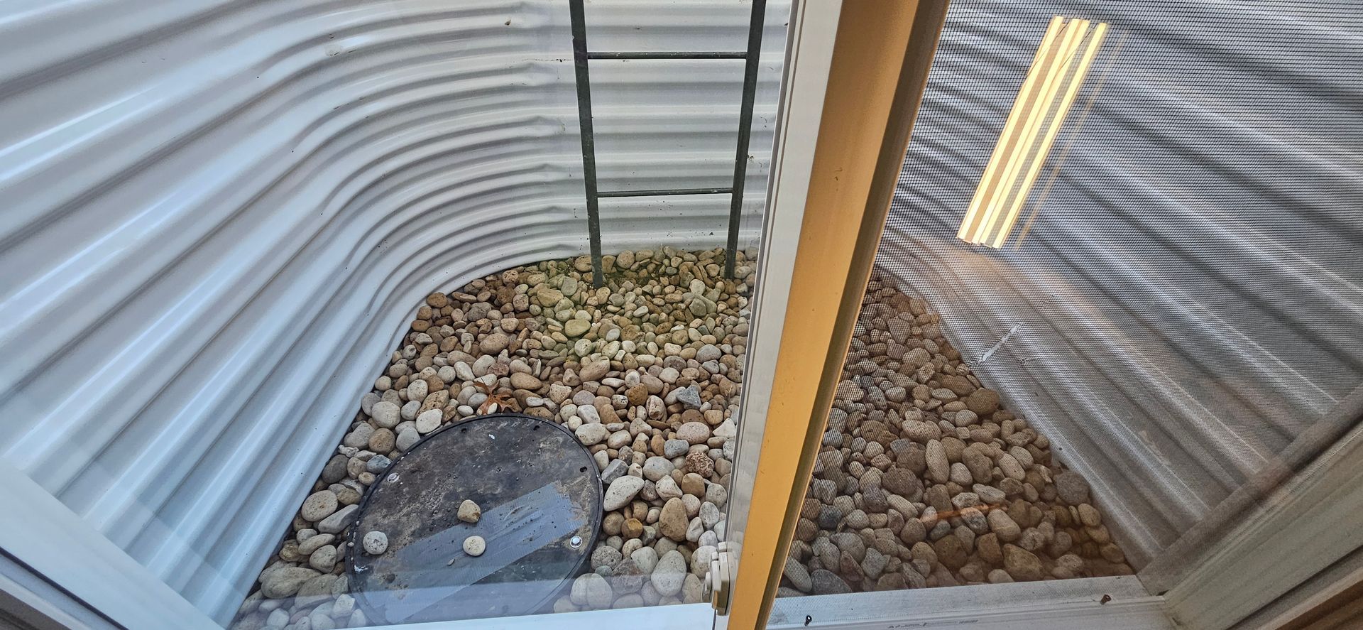 A ladder is hanging from the side of a building.