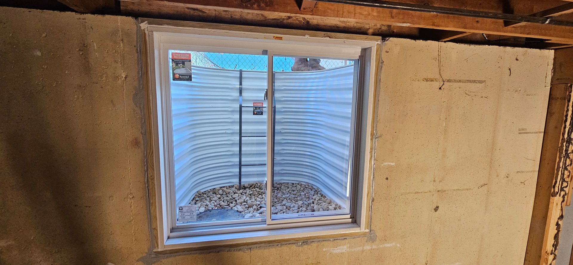 A window in a basement with a sliding glass door.