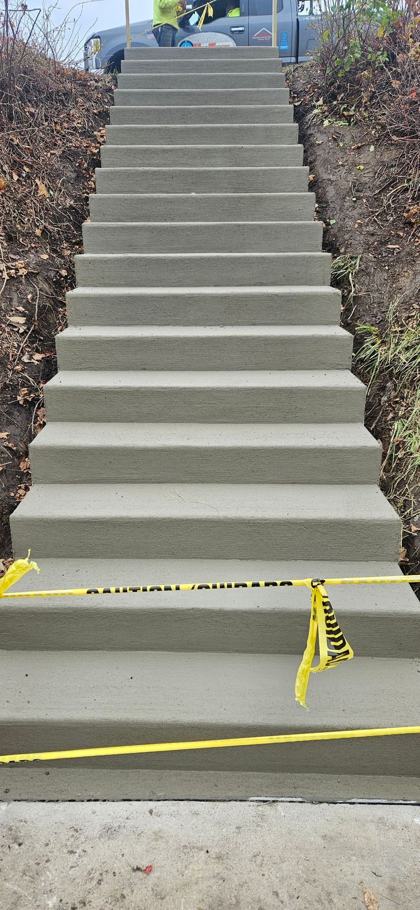 A set of concrete stairs going up a hill.