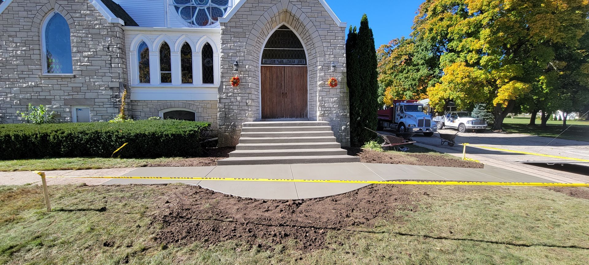 There is a pile of dirt in front of a church.