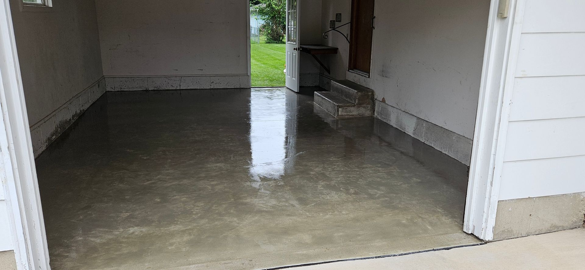 A concrete floor is being installed in a garage.
