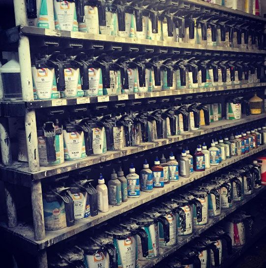 Shelves filled with lots of bottles and cans including one that has the number 1 on it