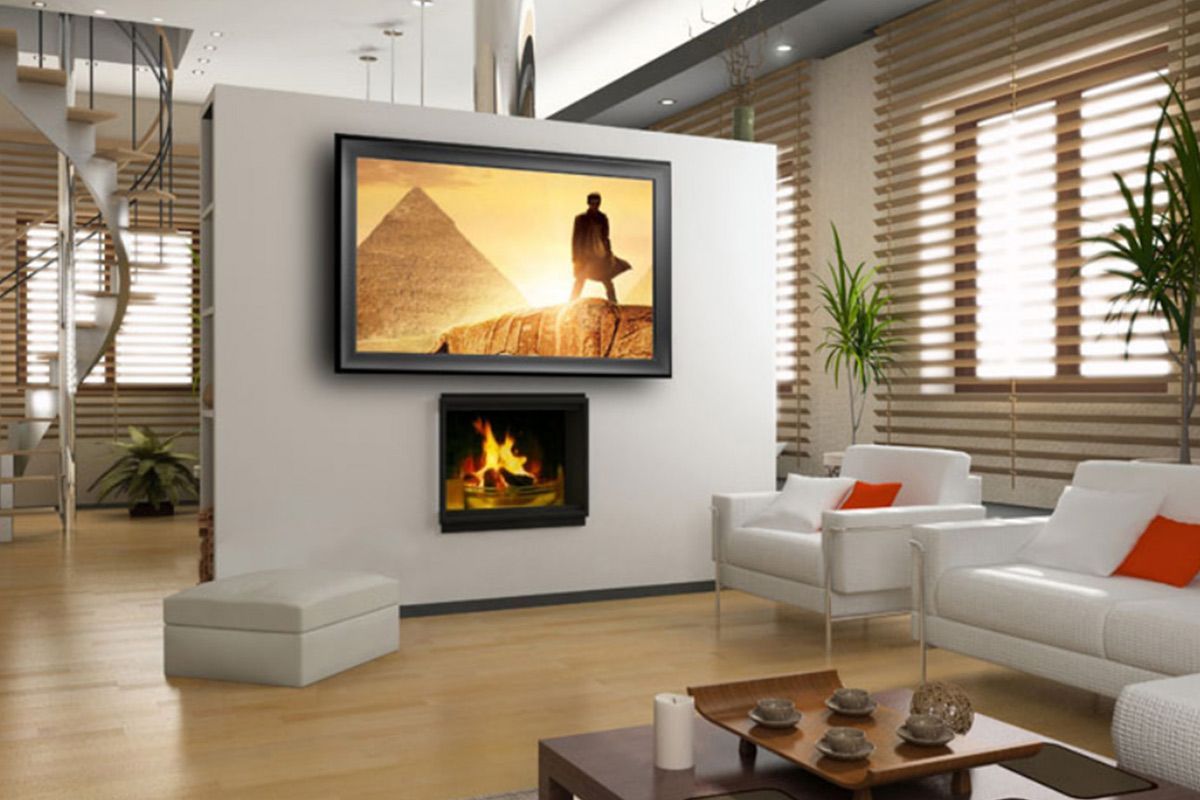 A living room with a couch and a television on the wall