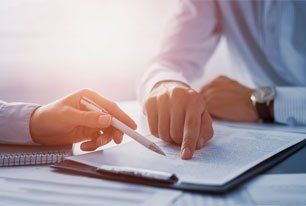 Human hands working with documents at desk