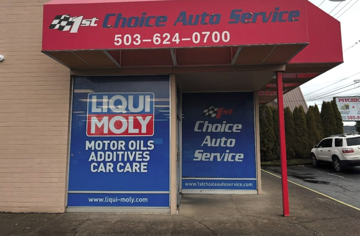 Exterior of 1st Choice Auto Service with blue and red signage, advertising Liqui Moly motor oils.