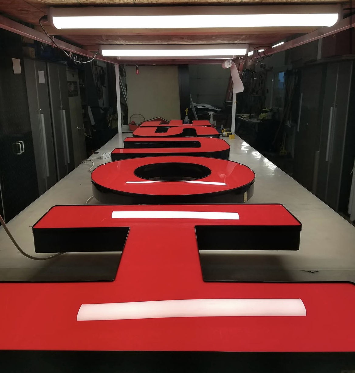 Red and black illuminated channel letters spelling 