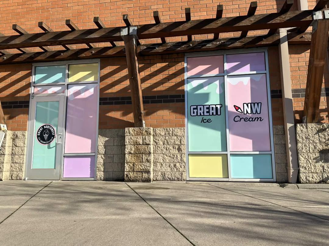 Two storefronts with colorful glass panels. The right one has 