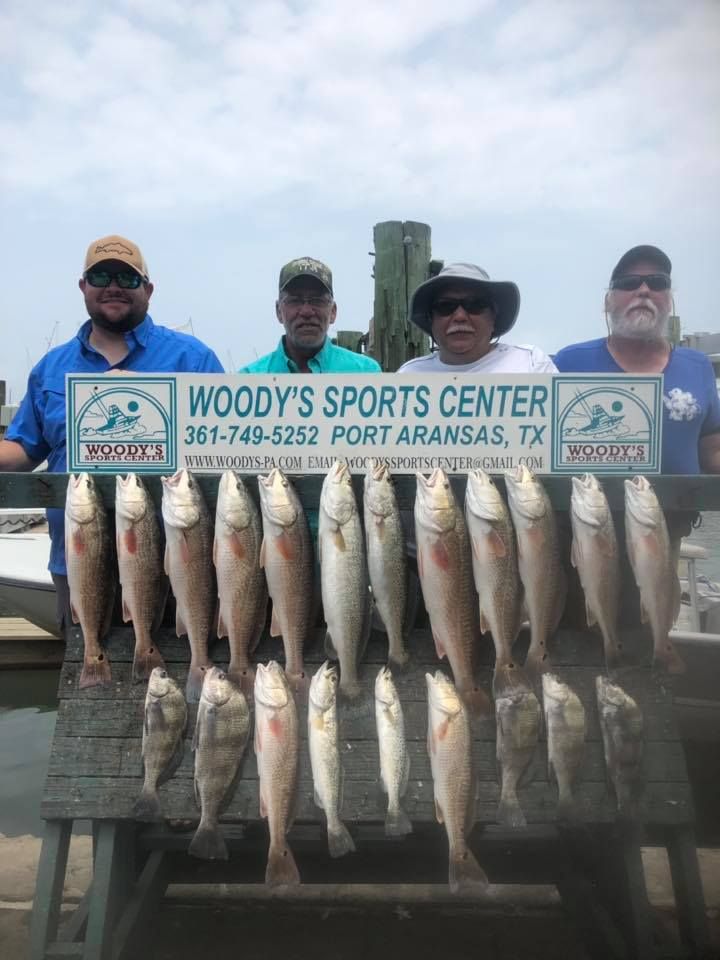 Four people with a large catch of fish at Woody's Sports Center in Port Aransas, Texas.
