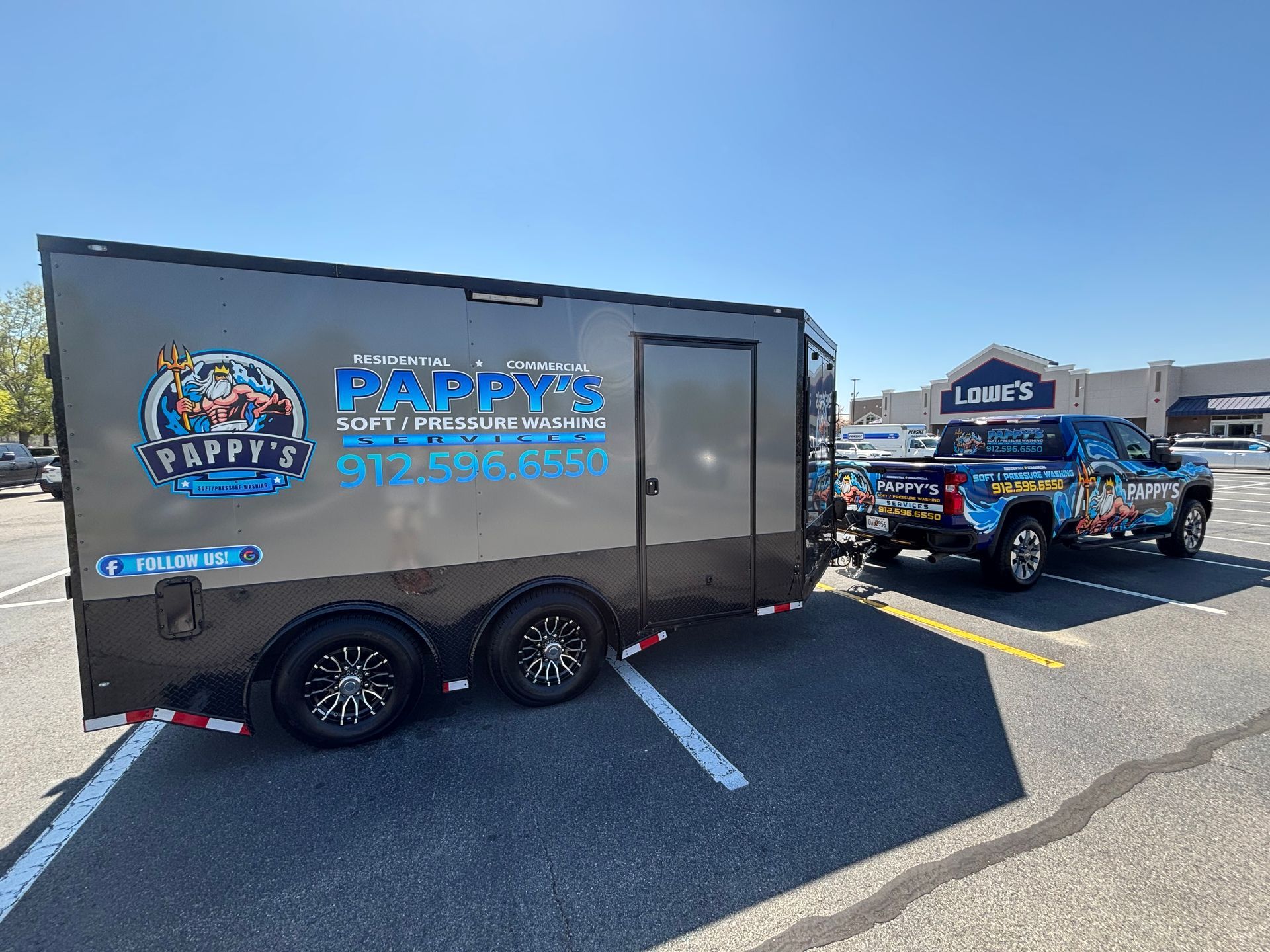 A truck is parked next to a trailer in a parking lot.