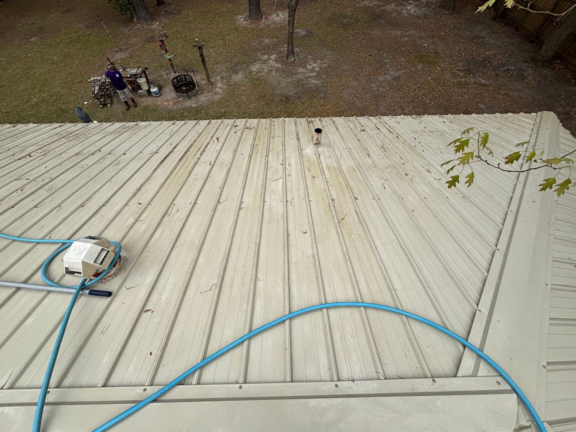 A white roof with a blue hose attached to it