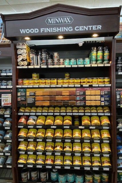 A wood finishing center in a store with lots of products