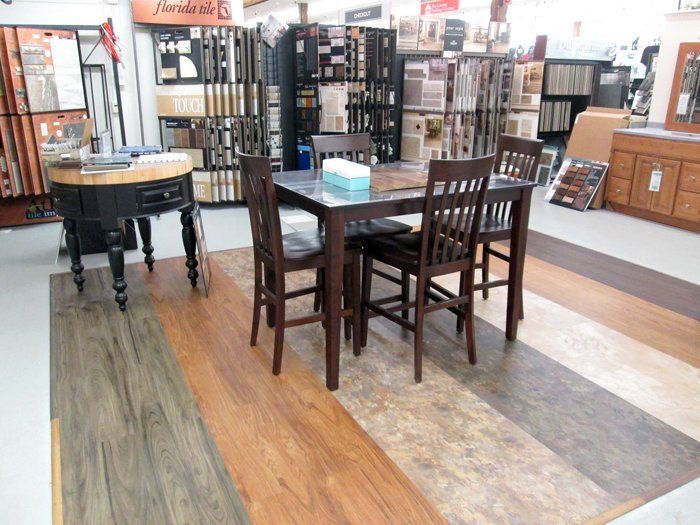 A dining room with a table and chairs in a store.
