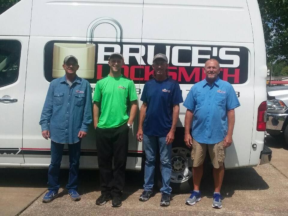 Four men in front of a van labeled 