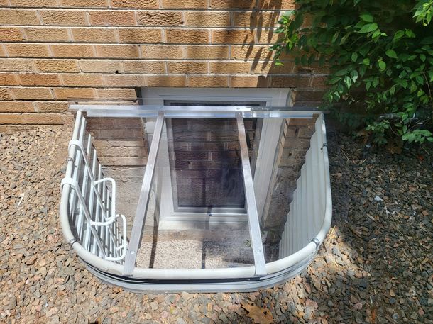 A wooden deck with a window in the middle of it
