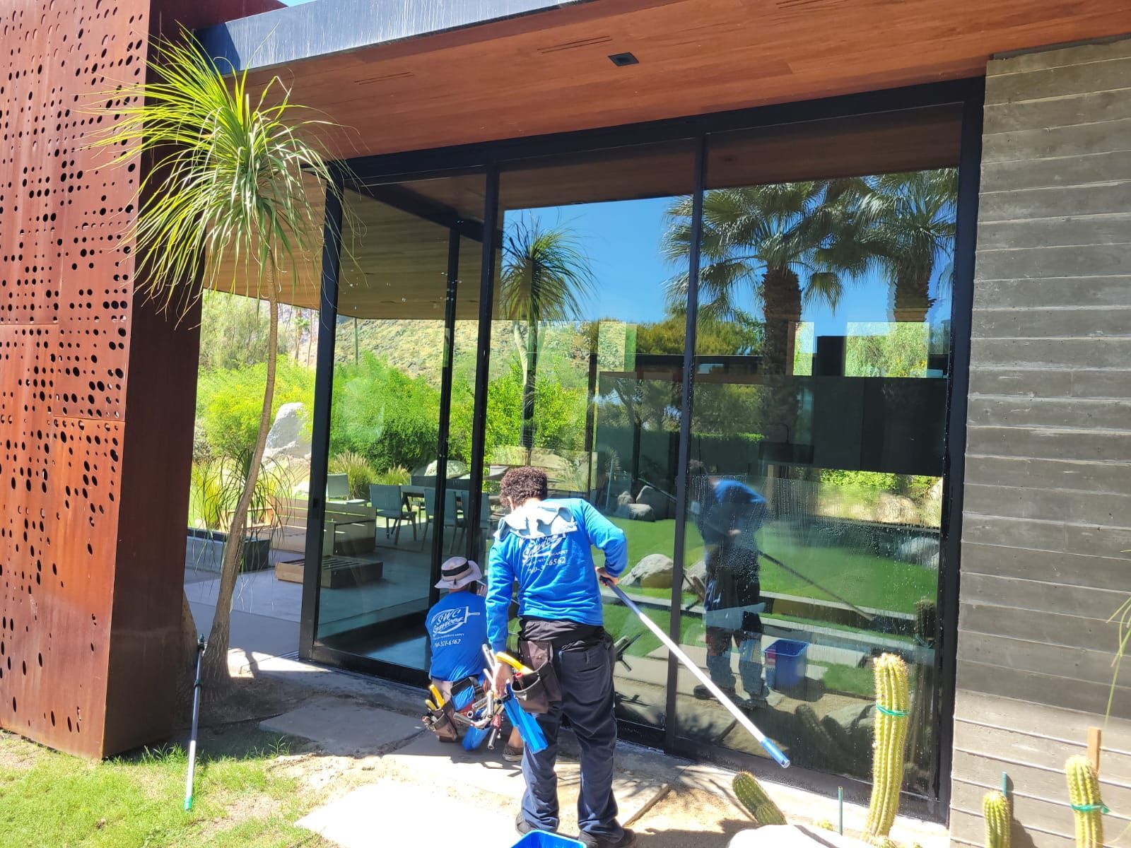 A man is cleaning the windows of a house.