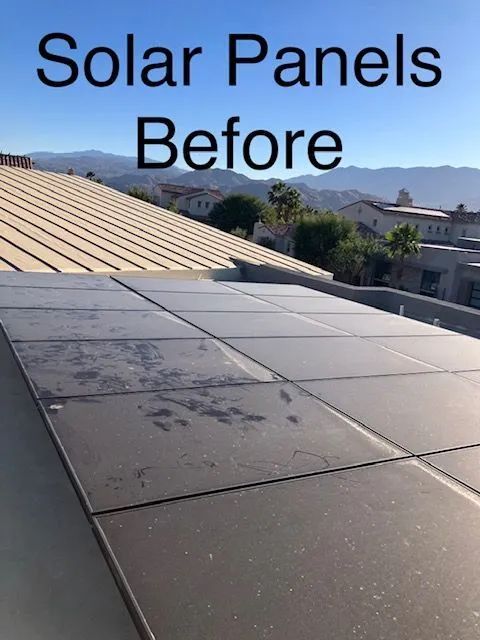 Solar panels on a roof before cleaning, showing significant dirt and grime.