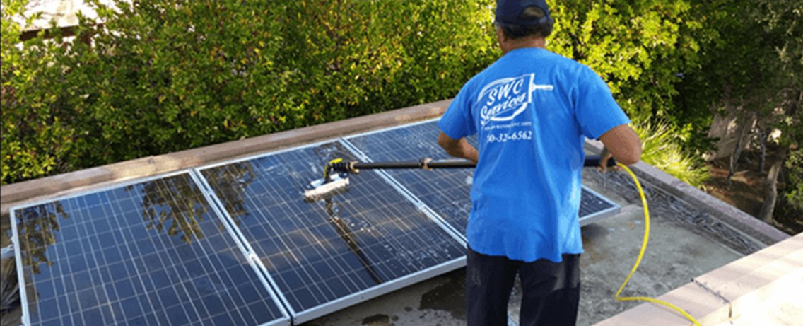 A worker cleaning solar panel