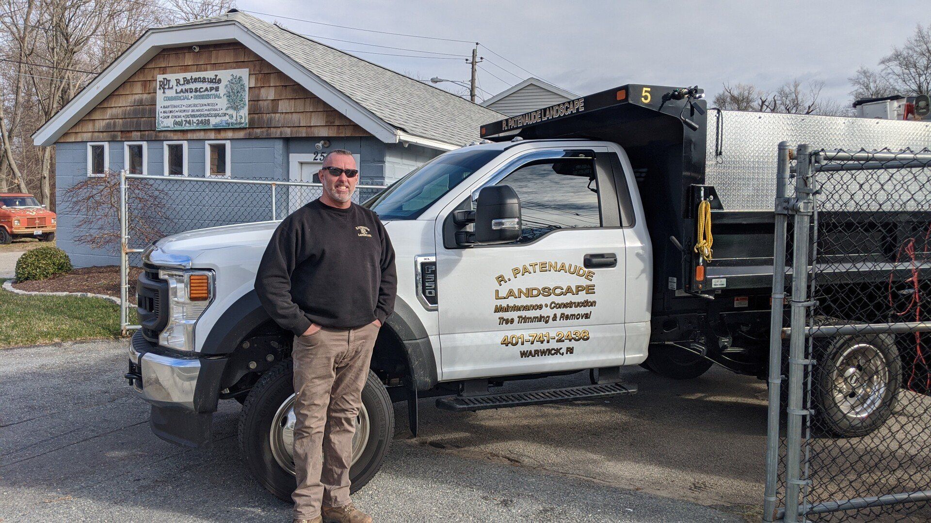Man in from of R Patenaude Landscape LLC's truck