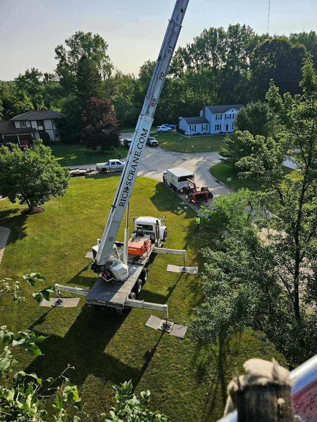 a large crane is sitting on top of a truck in a yard