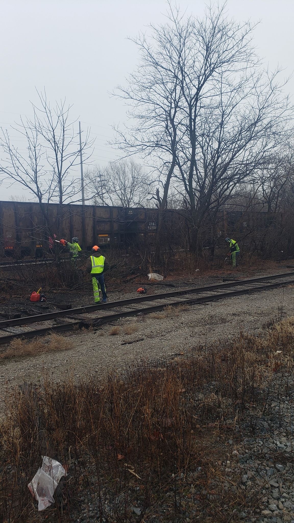 a group of people are standing on train tracks