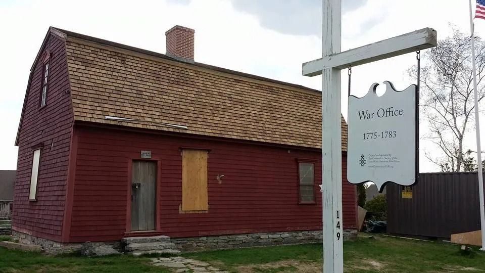 Red historic building with sign: 