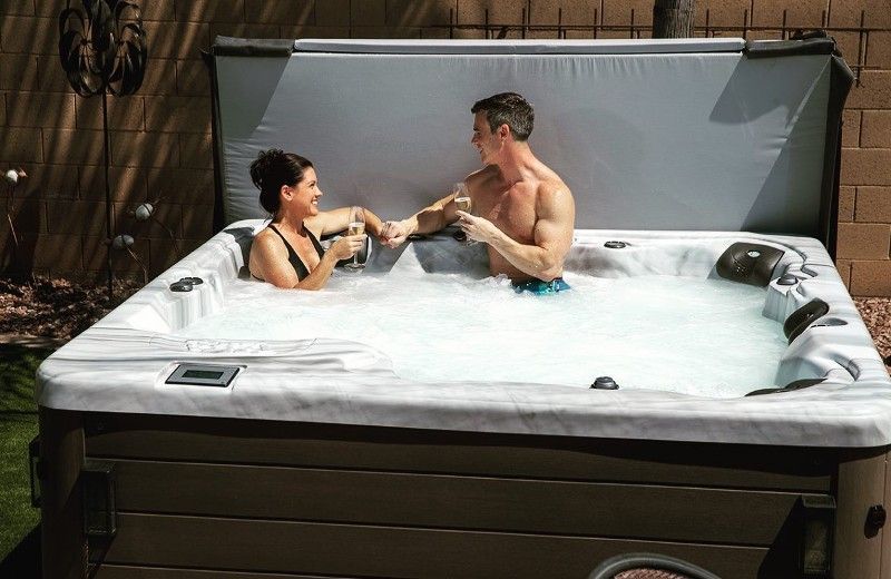 A man and a woman are sitting in a hot tub.