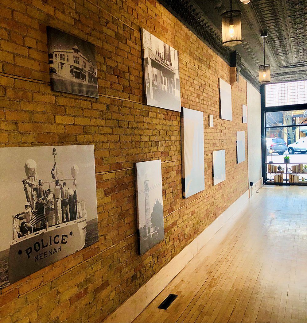 A long hallway with pictures on the wall that say police