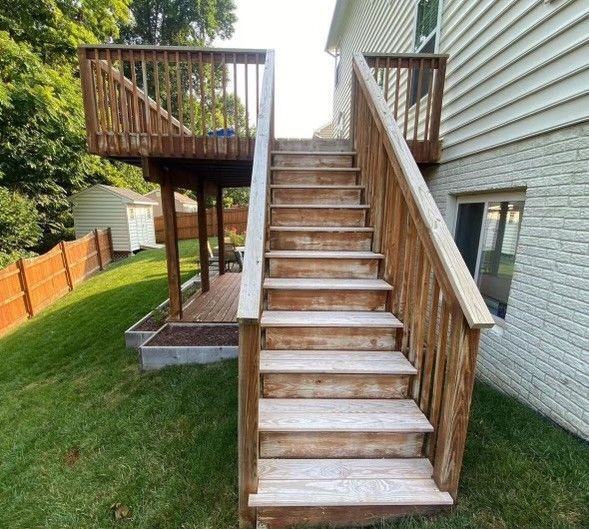 a wooden deck with stairs leading up to it