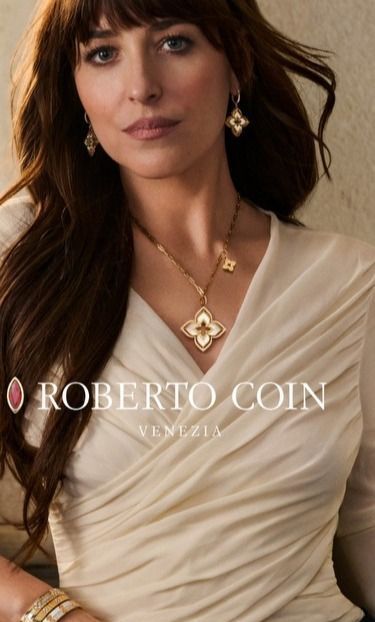 A model wearing Roberto Coin jewelry with long brown hair and bangs.