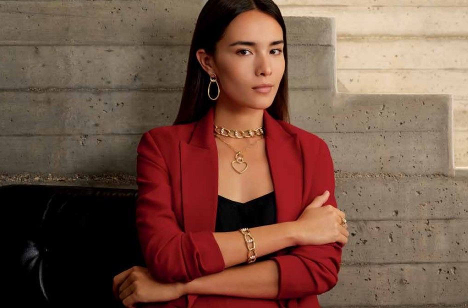 a woman in red and black wearing Roberto Coin jewelry