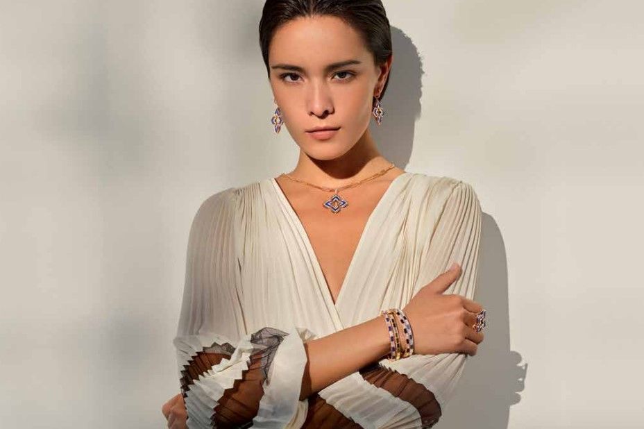 a woman in a white dress wearing Roberto Coin jewelry