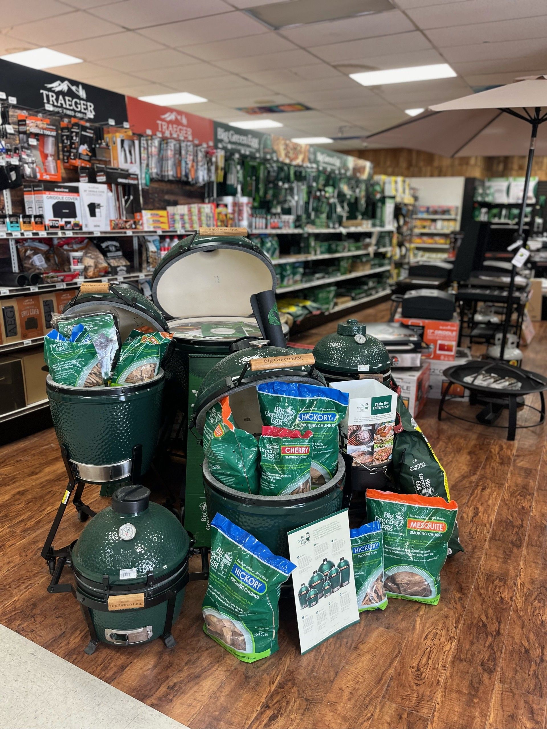 A store filled with lots of grills and bags of charcoal.
