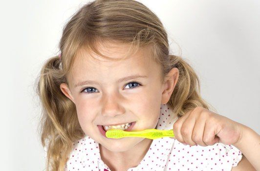 Young girl brushing teeth
