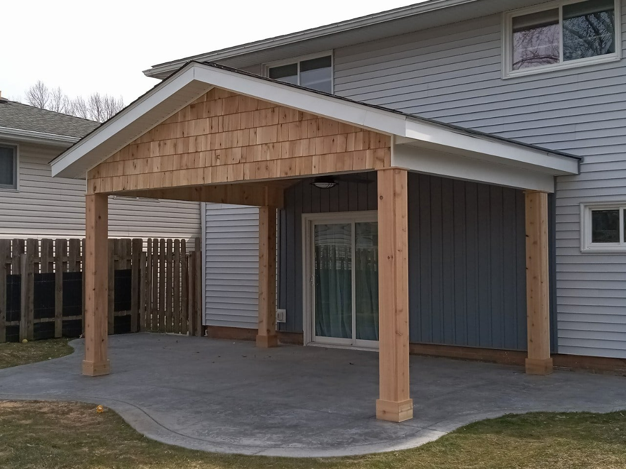 A house with a covered patio in front of it