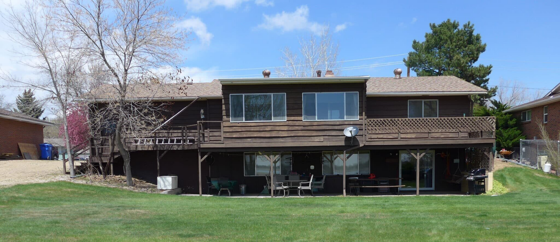 Two-story house with a wooden deck remodel - before